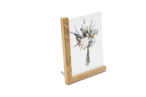 Holzrahmen in L-Form, der ein Bild mit einem Blumenstrau&szlig; h&auml;lt; der Strau&szlig; besteht aus wei&szlig;en, cremefarbenen und bl&auml;ulichen Blumen sowie gr&uuml;nen Bl&auml;ttern. Der Rahmen steht aufrecht, mit sichtbarer Metallst&uuml;tze auf der R&uuml;ckseite.